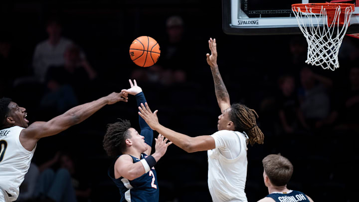 Virginia guard Chance Mallory (2) between Vanderbilt forward Tyler Harris (8) and forward AK Okereke (10) during the second half of their exhibition game at Memorial Gym in Nashville, Tenn., Thursday, Oct. 16, 2025.