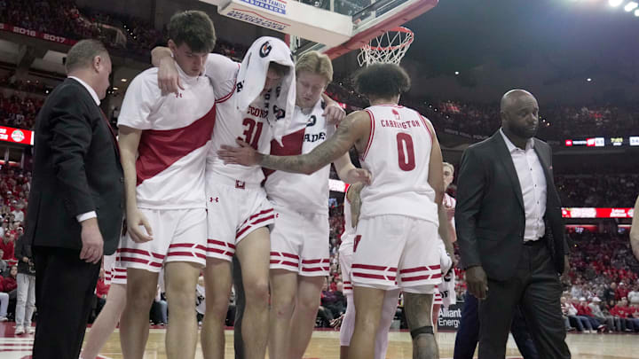 Wisconsin forward Nolan Winter (31) is helped off the court after being injured during the second half of their game Wednesday, March 4, 2026 at the Kohl Center in Madison, Wisconsin. Wisconsin beat Maryland 78-45.