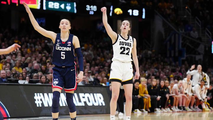Apr 5, 2024; Cleveland, OH, USA; Iowa Hawkeyes guard Caitlin Clark (22) and Connecticut Huskies guard Paige Bueckers (5) react in the second quarter in the semifinals of the Final Four of the womens 2024 NCAA Tournament at Rocket Mortgage FieldHouse. Mandatory Credit: Kirby Lee-Imagn Images