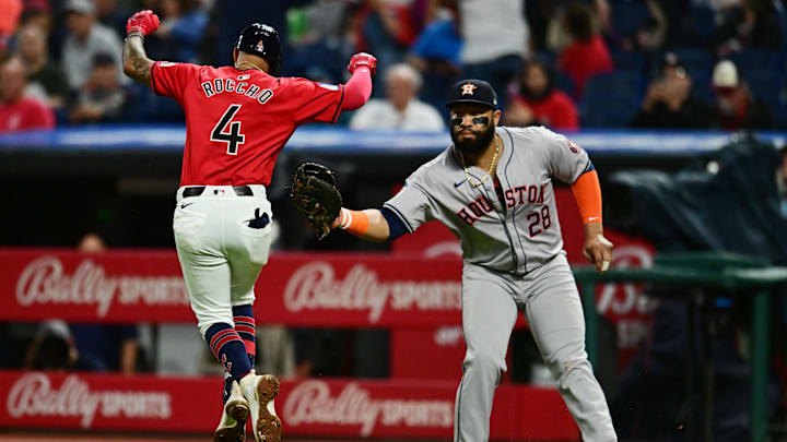 Sep 28, 2024; Cleveland, Ohio, USA; Houston Astros first baseman Jon Singleton (28) tags out Cleveland Guardians shortstop Brayan Rocchio (4) during the fourth inning at Progressive Field. Mandatory Credit: Ken Blaze-Imagn Images