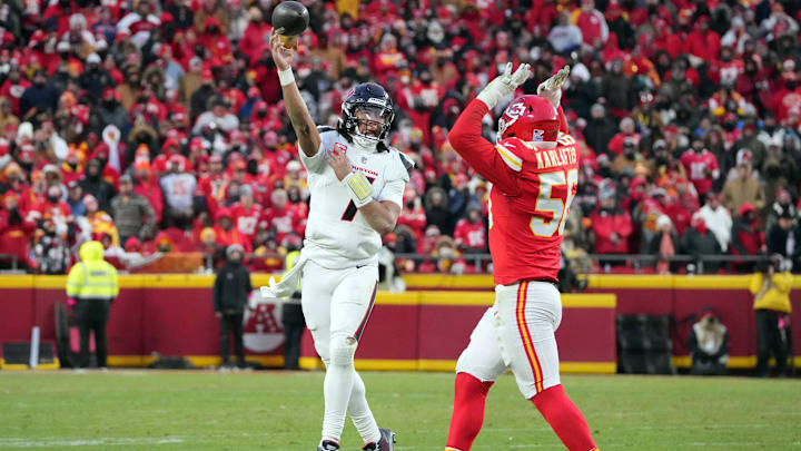 Jan 18, 2025; Kansas City, Missouri, USA; Houston Texans quarterback C.J. Stroud (7) throws the ball against Kansas City Chiefs defensive end George Karlaftis (56) during the third quarter of a 2025 AFC divisional round game at GEHA Field at Arrowhead Stadium. Mandatory Credit: Denny Medley-Imagn Images