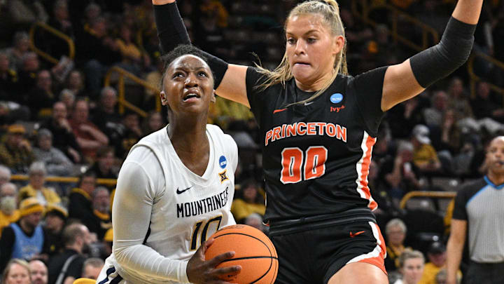 Mar 23, 2024; Iowa City, IA, USA; West Virginia Mountaineers guard Jordan Harrison (10) goes to the basket as Princeton Tigers forward Ellie Mitchell (00) defends during the first quarter of the NCAA first round game at Carver-Hawkeye Arena. Mandatory Credit: Jeffrey Becker-Imagn Images