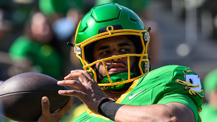 Aug 31, 2024; Eugene, Oregon, USA; Oregon Ducks quarterback Dante Moore (5) warms up before the game against the Idaho Vandals at Autzen Stadium. 