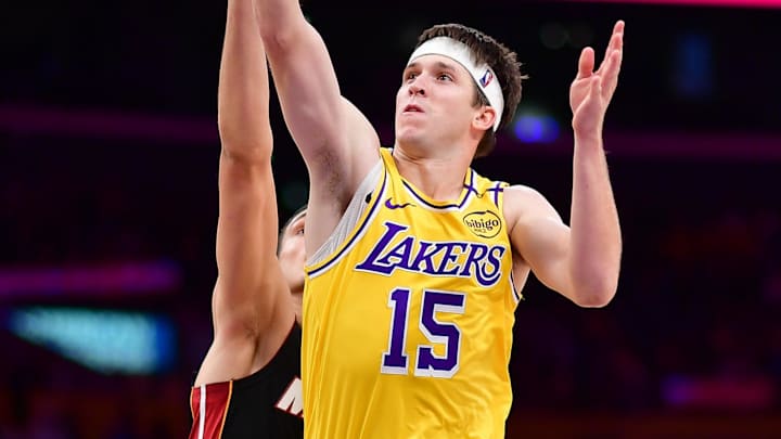 January 15, 2025; Los Angeles, California, USA; Los Angeles Lakers guard Austin Reaves (15) shoots against the Miami Heat during the second half at Crypto.com Arena. Mandatory Credit: Gary A. Vasquez-Imagn Images