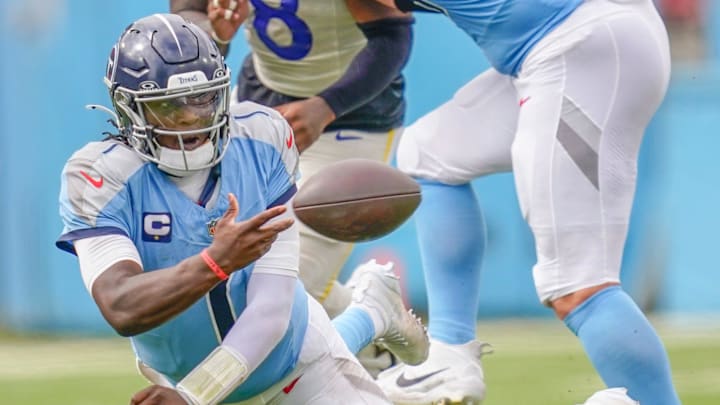 Tennessee Titans quarterback Cam Ward (1) gets a pass off as he falls during the fourth quarter against the Los Angeles Rams at Nissan Stadium in Nashville, Tenn., Sunday, Sept. 14, 2025.