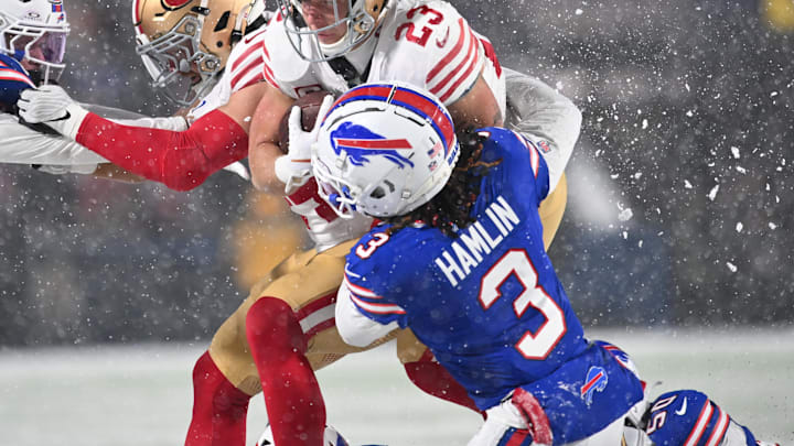 Dec 1, 2024; Orchard Park, New York, USA; San Francisco 49ers running back Christian McCaffrey (23) is tackled by Buffalo Bills safety Damar Hamlin (3) =