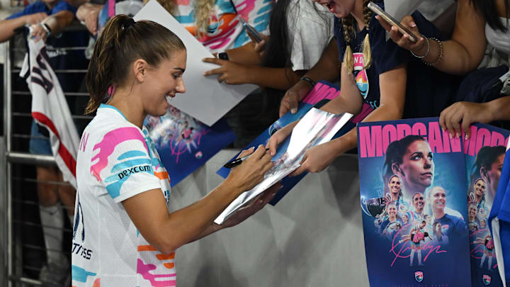Sep 8, 2024; San Diego, California, USA; San Diego Wave FC forward Alex Morgan (13) signs autographs for fans following her final match 