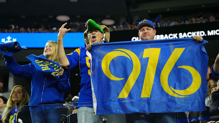 Dec 28, 2024; Inglewood, California, USA; A Los Angeles Rams fan holds a 916 area code banner in the second half against the Arizona Cardinals at SoFi Stadium. Mandatory Credit: Kirby Lee-Imagn Images