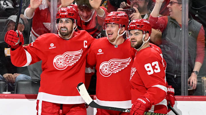 Mar 29, 2025; Detroit, Michigan, USA; Detroit Red Wings left wing Lucas Raymond (23) celebrates with Detroit Red Wings center Dylan Larkin (71) and Detroit Red Wings right wing Alex DeBrincat (93) after scoring a power play goal against the Boston Bruins in the second period at Little Caesars Arena. Mandatory Credit: Lon Horwedel-Imagn Images