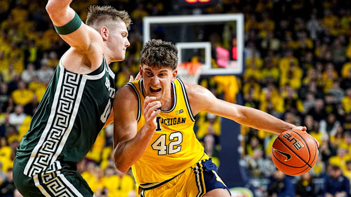 Michigan forward Will Tschetter (42) dribbles against Michigan State forward Jaxon Kohler (0) during the first half at Crisler Center in Ann Arbor on Sunday, March 8, 2026.