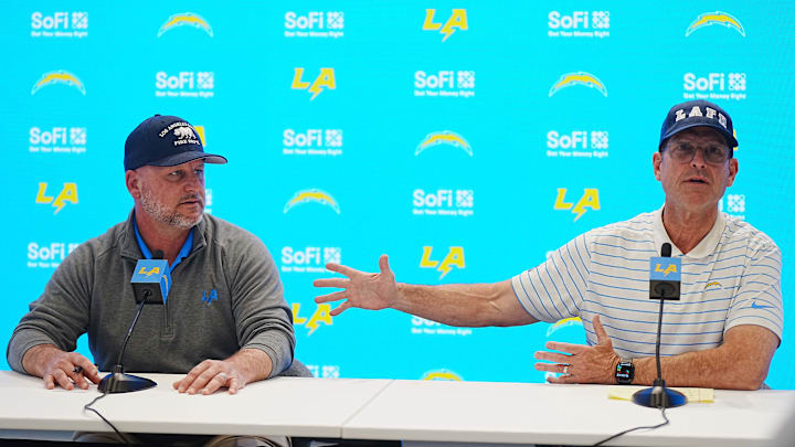 Jan 15, 2025; El Segundo, CA, USA; Los Angeles Chargers general manager Joe Hortiz (left) and coach Jim Harbaugh.
