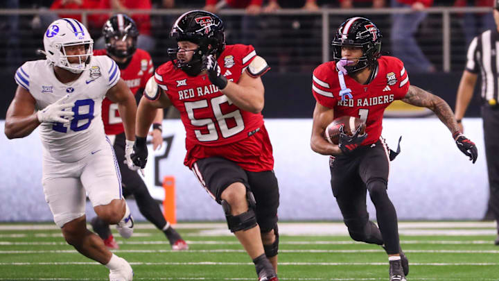 Texas Tech's Reggie Virgil (right) follows a block from Davion Carter on a catch and run against BYU during the Big 12 Conference championship football game, Saturday, Nov. 6, 2025, at AT&T Stadium in Arlington.