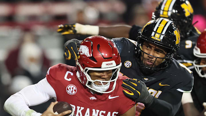 Nov 29, 2025; Fayetteville, Arkansas, USA; Arkansas Razorbacks quarterback Taylen Green (10) is sacked by Missouri Tigers defensive end Zion Young (9) during the fourth quarter at Donald W. Reynolds Razorback Stadium. Missouri won 31-17. Mandatory Credit: Nelson Chenault-Imagn Images