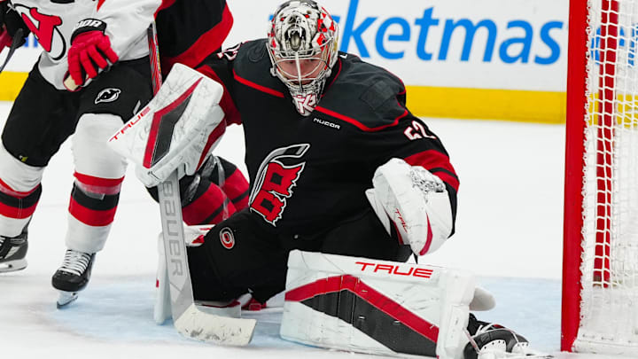 Apr 29, 2025; Raleigh, North Carolina, USA; Carolina Hurricanes goaltender Pyotr Kochetkov (52) makes a save against the New Jersey Devils during the second period in game five of the first round of the 2025 Stanley Cup Playoffs at Lenovo Center. Mandatory Credit: James Guillory-Imagn Images
