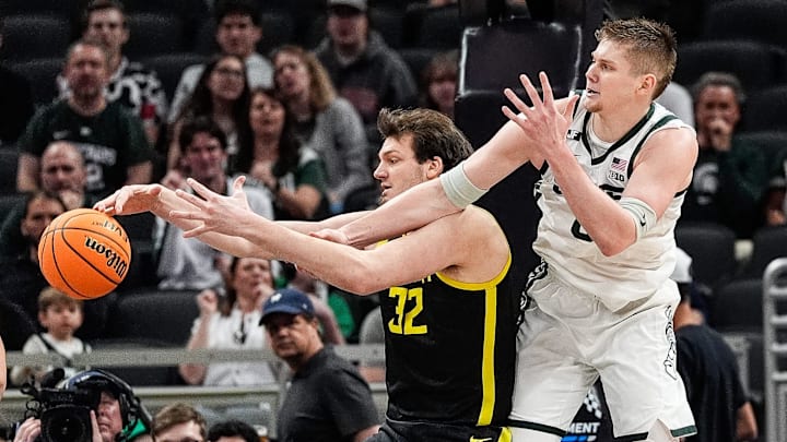 Oregon center Nate Bittle grabs a rebound against Michigan State forward Jaxon Kohler during the first half of the Big Ten Tournament quarterfinal at Gainbridge Fieldhouse in Indianapolis on Friday, March 14, 2025.