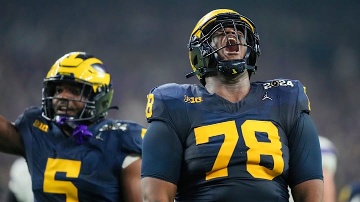 Michigan defensive lineman Kenneth Grant celebrates a sack on Washington quarterback Michael Penix Jr. in the second quarter during the College Football Playoff national championship game against Washington at NRG Stadium in Houston, Texas on Monday, Jan. 8, 2024.