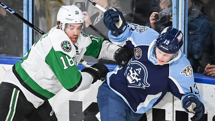 Texas Stars left wing Curtis McKenzie (16) and Milwaukee Admirals center Juuso Parssinen (13) crash into the glass during the second period of their game Saturday, February 10, 2024, at the UW-Milwaukee Panther Arena in Milwaukee, Wisconsin.