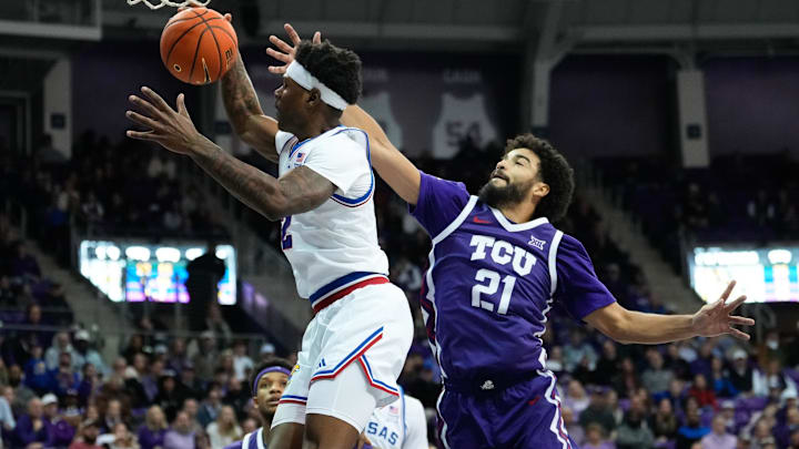 Jan 22, 2025; Fort Worth, Texas, USA;  Kansas Jayhawks guard AJ Storr (2) grabs a rebound against TCU Horned Frogs guard Noah Reynolds (21) during the second half at Ed and Rae Schollmaier Arena. Mandatory Credit: Chris Jones-Imagn Images