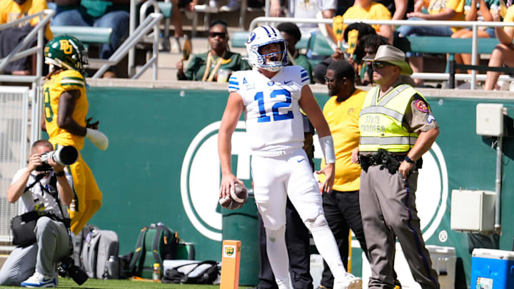 Sep 28, 2024; Waco, Texas, USA; Brigham Young Cougars quarterback Jake Retzlaff (12) celebrates after scoring a touchdown against the Baylor Bears during the first half at McLane Stadium. Sep 28, 2024; Waco, Texas, USA; Brigham Young Cougars quarterback Jake Retzlaff (12) celebrates after scoring a touchdown against the Baylor Bears during the first half at McLane Stadium.