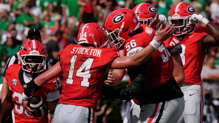 Georgia quarterback Gunner Stockton (14) celebrates with his teammates after scoring a touchdown during the first half of a NCAA college football game against Marshall in Athens, Ga., on Saturday, August. 30, 2025.