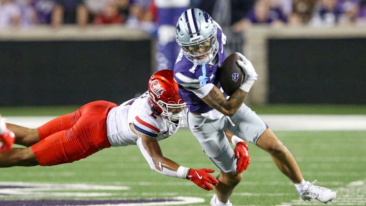 Sep 13, 2024; Manhattan, Kansas, USA; Kansas State Wildcats wide receiver Jayce Brown (1) runs away from Arizona Wildcats defensive back Treydan Stukes (2) during the fourth quarter at Bill Snyder Family Football Stadium. Sep 13, 2024; Manhattan, Kansas, USA; Kansas State Wildcats wide receiver Jayce Brown (1) runs away from Arizona Wildcats defensive back Treydan Stukes (2) during the fourth quarter at Bill Snyder Family Football Stadium.