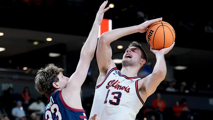 Mar 19, 2026; Greenville, SC, USA; Illinois Fighting Illini center Tomislav Ivisic (13) goes to the basket against Penn Quakers center Michelangelo Oberti (33) in the second half of a first round game of the men's 2026 NCAA Tournament at Bon Secours Wellness Arena. Mandatory Credit: Jim Dedmon-Imagn Images