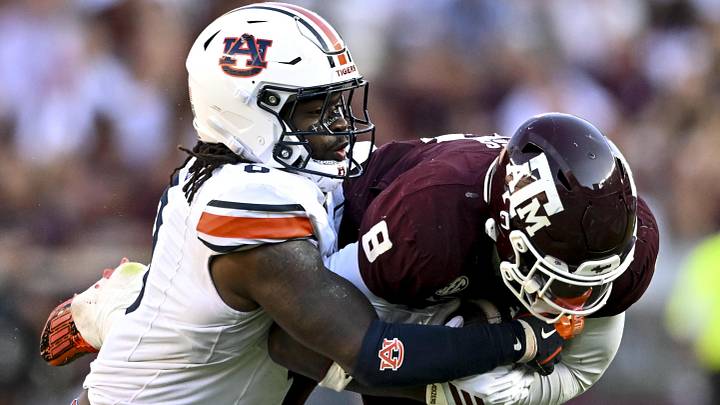 Sep 27, 2025; College Station, Texas, USA; Auburn Tigers linebacker Robert Woodyard Jr. (0) wraps up Texas A&M Aggies running back Le'Veon Moss (8) during the third quarter at Kyle Field. Sep 27, 2025; College Station, Texas, USA; Auburn Tigers linebacker Robert Woodyard Jr. (0) wraps up Texas A&M Aggies running back Le'Veon Moss (8) during the third quarter at Kyle Field.