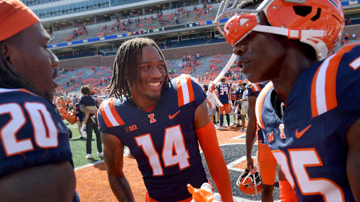 Sep 14, 2024; Champaign, Illinois, USA;  Illinois Fighting Illini defensive back Xavier Scott (14) and teammates celebrate after a 30-9 victory over the Central Michigan Chippewas at Memorial Stadium. Mandatory Credit: Ron Johnson-Imagn Images