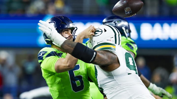 Green Bay Packers defensive tackle Kenny Clark (97) pressures Seattle Seahawks quarterback Sam Howell.