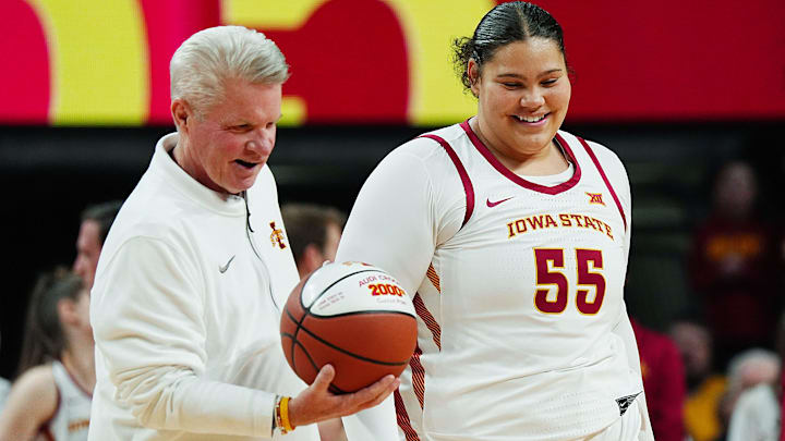Iowa State Cyclones' center Audi Crooks (55) receives the ball from head coach Bill Fennelly in honor her 2000- career point before Iowa State and UFC women’s basketball on Jan. 31, 2026, at Hilton Coliseum in Ames, Iowa.
