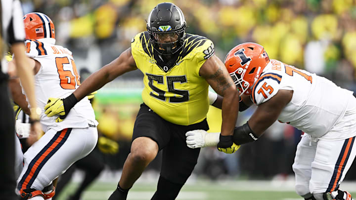 Oct 26, 2024; Eugene, Oregon, USA; Oregon Ducks defensive lineman Derrick Harmon (55) breaks past Illinois Fighting Illini offensive lineman Brandon Henderson (75) during the second half at Autzen Stadium. 