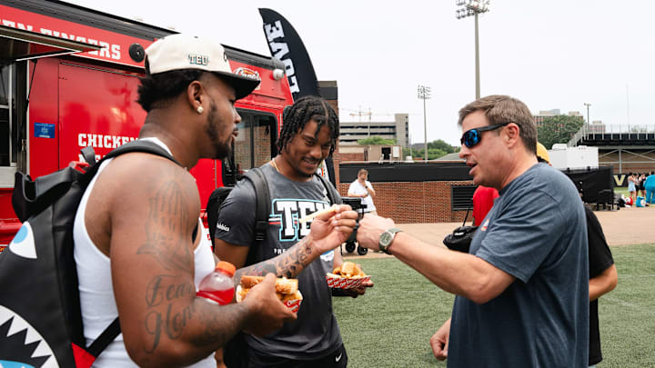 Ja'Tavion Sanders, Isaiah Likely & Todd Graves enjoying hot, fresh Chicken Fingers at TEU