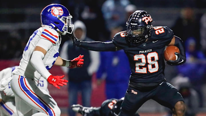 Pittsburg RB offers a stiff arm during the Pirates' 28-27 win over Folsom for the CIF Division 1-AA Northern California Regional title. 