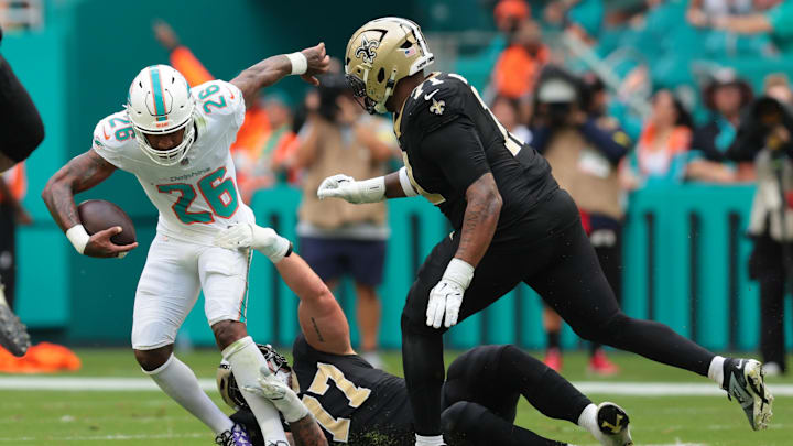 Miami Dolphins cornerback Rasul Douglas (26) carries the ball after making an interception as New Orleans Saints offensive tackle Dillon Radunz (77) attempts to make the tackle during the first half at Hard Rock Stadium. Miami Dolphins cornerback Rasul Douglas (26) carries the ball after making an interception as New Orleans Saints offensive tackle Dillon Radunz (77) attempts to make the tackle during the first half at Hard Rock Stadium.