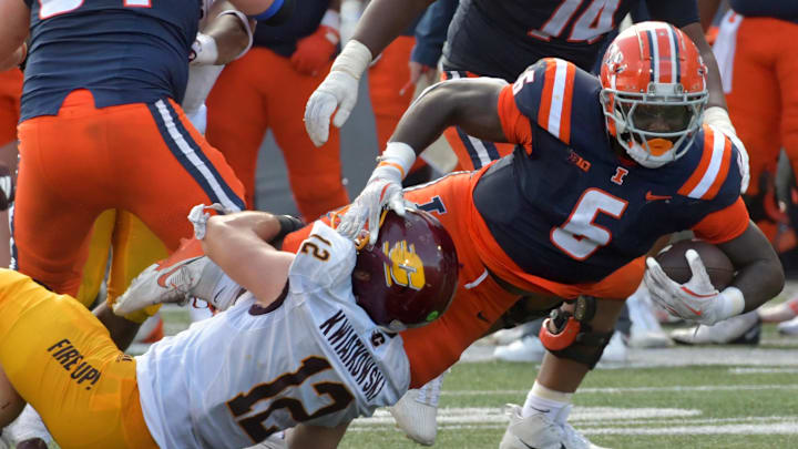 Sep 14, 2024; Champaign, Illinois, USA;  Illinois Fighting Illini running back Josh McCray (6) is brought down by Central Michigan Chippewas linebacker Jordan Kwiatkowski (12) during the second half at Memorial Stadium. Mandatory Credit: Ron Johnson-Imagn Images
