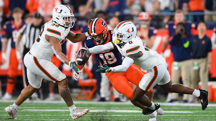 Miami Hurricanes linebacker Raul Aguirre Jr. (32) and defensive back Mishael Powell (0) break up a pass intended for Syracuse Orange tight end Oronde Gadsden II (19) during the first half at the JMA Wireless Dome. Miami Hurricanes linebacker Raul Aguirre Jr. (32) and defensive back Mishael Powell (0) break up a pass intended for Syracuse Orange tight end Oronde Gadsden II (19) during the first half at the JMA Wireless Dome.