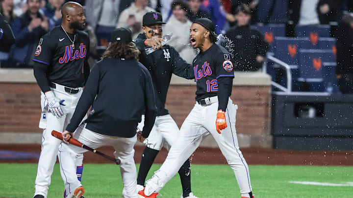 Apr 18, 2025; New York City, New York, USA;  New York Mets shortstop Francisco Lindor (12) celebrates with his teammates after hitting a game-winning solo home run in the ninth inning against the St. Louis Cardinals at Citi Field. Mandatory Credit: Wendell Cruz-Imagn Images