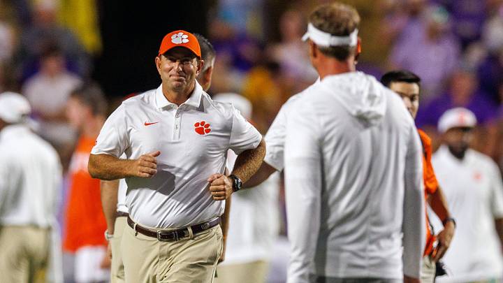 Clemson Tigers head coach Dabo Swinney runs to greet LSU Tigers head coach Lane Kiffin before a game at Tiger Stadium. Clemson Tigers head coach Dabo Swinney runs to greet LSU Tigers head coach Lane Kiffin before a game at Tiger Stadium.
