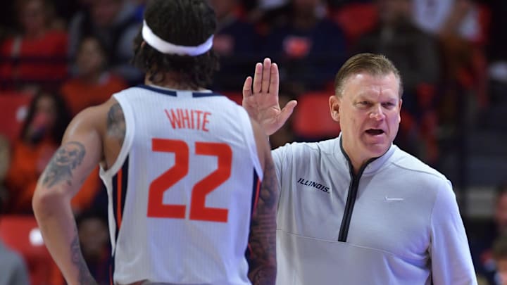 Nov 23, 2024; Champaign, Illinois, USA;  Illinois Fighting Illini head coach Brad Underwood gives a hand to guard Tre White (22) during the second half against the Maryland-Eastern Shore Hawks at State Farm Center. Mandatory Credit: Ron Johnson-Imagn Images