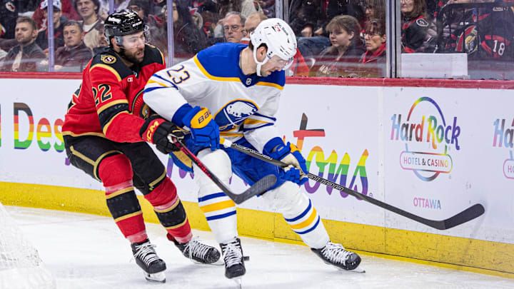 Apr 2, 2026; Ottawa, Ontario, CAN; Ottawa Senators right wing Michael Amadio (22) and Buffalo Sabres defenseman Mattias Samuelsson (23) battle for the puck in the first period at the Canadian Tire Centre. Mandatory Credit: Marc DesRosiers-IMAGN Images