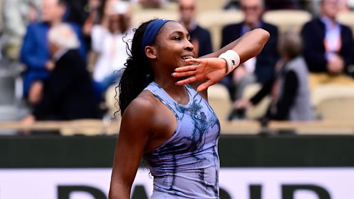 Coco Gauff waves to fans after her first round match at Roland Garros.