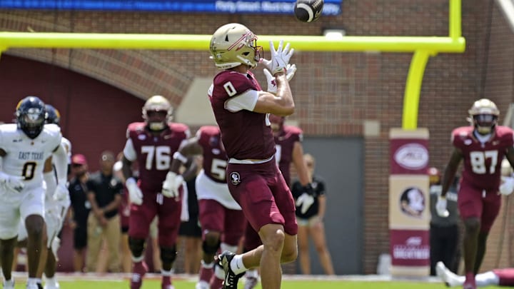 Sep 6, 2025; Tallahassee, Florida, USA; Florida State Seminoles wide receiver Duce Robinson (0) catches a touchdown during the first half against the East Texas A&M at Doak S. Campbell Stadium. Mandatory Credit: Melina Myers-Imagn Images