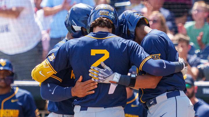 Jun 16, 2026; Omaha, NE, USA; West Virginia Mountaineers second baseman Gavin Kelly (2), third baseman Tyrus Hall (8) and right fielder Armani Guzman (5) embrace after a three-run home run by Kelly against the Troy Trojans during the sixth inning at Charles Schwab Field. Mandatory Credit: Dylan Widger-Imagn Images Jun 16, 2026; Omaha, NE, USA; West Virginia Mountaineers second baseman Gavin Kelly (2), third baseman Tyrus Hall (8) and right fielder Armani Guzman (5) embrace after a three-run home run by Kelly against the Troy Trojans during the sixth inning at Charles Schwab Field. Mandatory Credit: Dylan Widger-Imagn Images