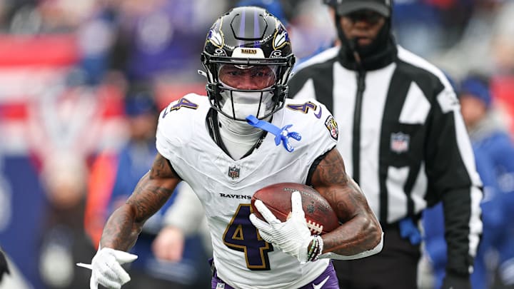 Dec 15, 2024; East Rutherford, New Jersey, USA; Baltimore Ravens wide receiver Zay Flowers (4) carries the ball against the New York Giants during the first quarter at MetLife Stadium. Mandatory Credit: Vincent Carchietta-Imagn Images