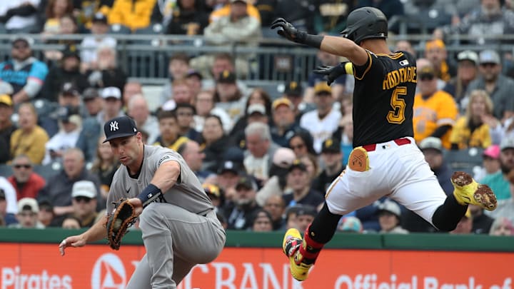 Apr 4, 2025; Pittsburgh, Pennsylvania, USA;  New York Yankees first base Paul Goldschmidt (left) takes a throw to retire Pittsburgh Pirates first baseman Endy Rodriguez (5) at first base during the second inning at PNC Park. Mandatory Credit: Charles LeClaire-Imagn Images