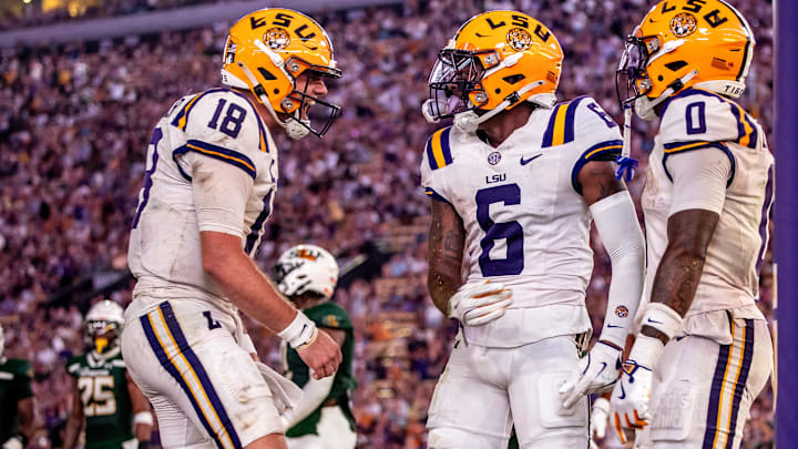 Sep 20, 2025; Baton Rouge, Louisiana, USA;  LSU Tigers wide receiver Barion Brown (6) and LSU Tigers quarterback Garrett Nussmeier (18) react to scoring a touchdown against the Southeastern Louisiana Lions during the first half at Tiger Stadium. Mandatory Credit: Stephen Lew-Imagn Images