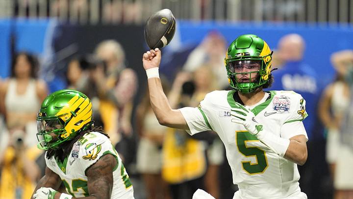 Jan 9, 2026; Atlanta, GA, USA; Oregon Ducks quarterback Dante Moore (5) fumbles against the Indiana Hoosiers during the first half of the 2025 Peach Bowl and semifinal game of the College Football Playoff at Mercedes-Benz Stadium. Mandatory Credit: Dale Zanine-Imagn Images Jan 9, 2026; Atlanta, GA, USA; Oregon Ducks quarterback Dante Moore (5) fumbles against the Indiana Hoosiers during the first half of the 2025 Peach Bowl and semifinal game of the College Football Playoff at Mercedes-Benz Stadium. Mandatory Credit: Dale Zanine-Imagn Images