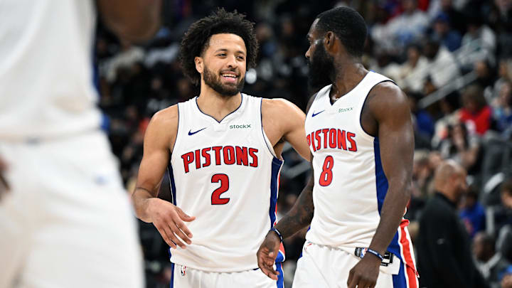 Jan 1, 2025; Detroit, Michigan, USA;  Detroit Pistons guard Cade Cunningham (2) and forward Tim Hardaway Jr. (8) begin to celebrate after Hardaway was fouled late in the fourth quarter against the Orlando Magic to help the Pistons to a victory at Little Caesars Arena. Mandatory Credit: Lon Horwedel-Imagn Images