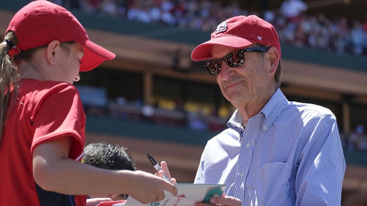 Jun 3, 2018; St. Louis, MO, USA; St. Louis Cardinals principal owner and chairman Bill DeWitt Jr. signs an autograph for a young fan during the seventh inning against the Pittsburgh Pirates at Busch Stadium. Mandatory Credit: Scott Rovak-Imagn Images