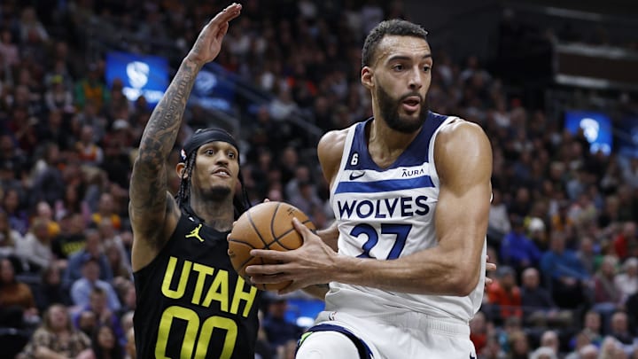 Dec 9, 2022; Salt Lake City, Utah, USA; Minnesota Timberwolves center Rudy Gobert (27 grabs a rebound against Utah Jazz guard Jordan Clarkson (00) in the second half at Vivint Arena. 